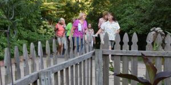 group of ladies walking toward fenced garden